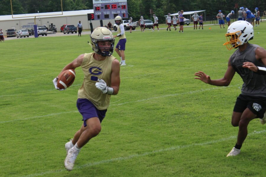 Gurdon receiver makes an effort to pick up as many yards as possible before being taken down by a defender at the 7 on 7 camp at Poyen.